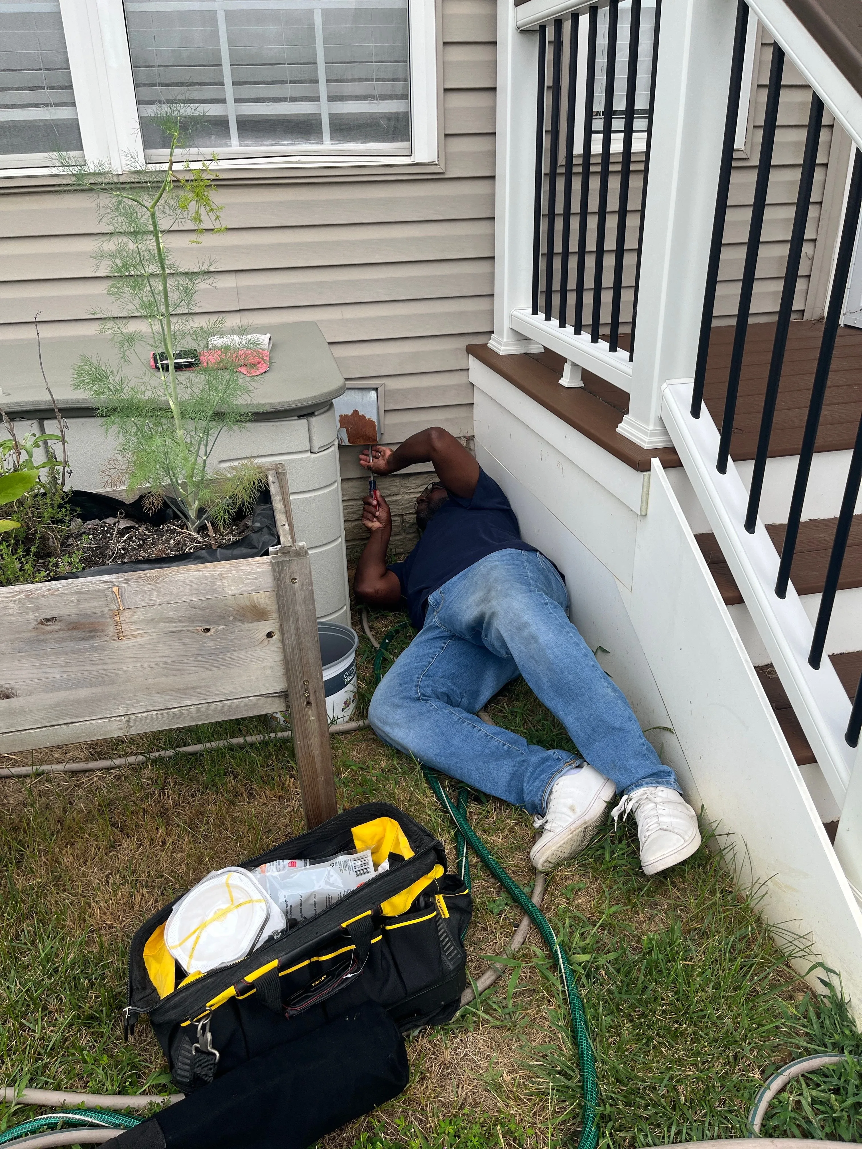 Kester servicing an exterior dryer vent hood at a Bowie, MD home.